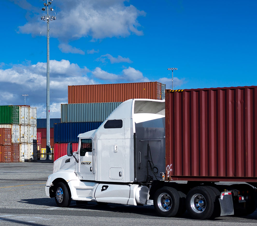 A Fastex transport pulling into a container yard. 