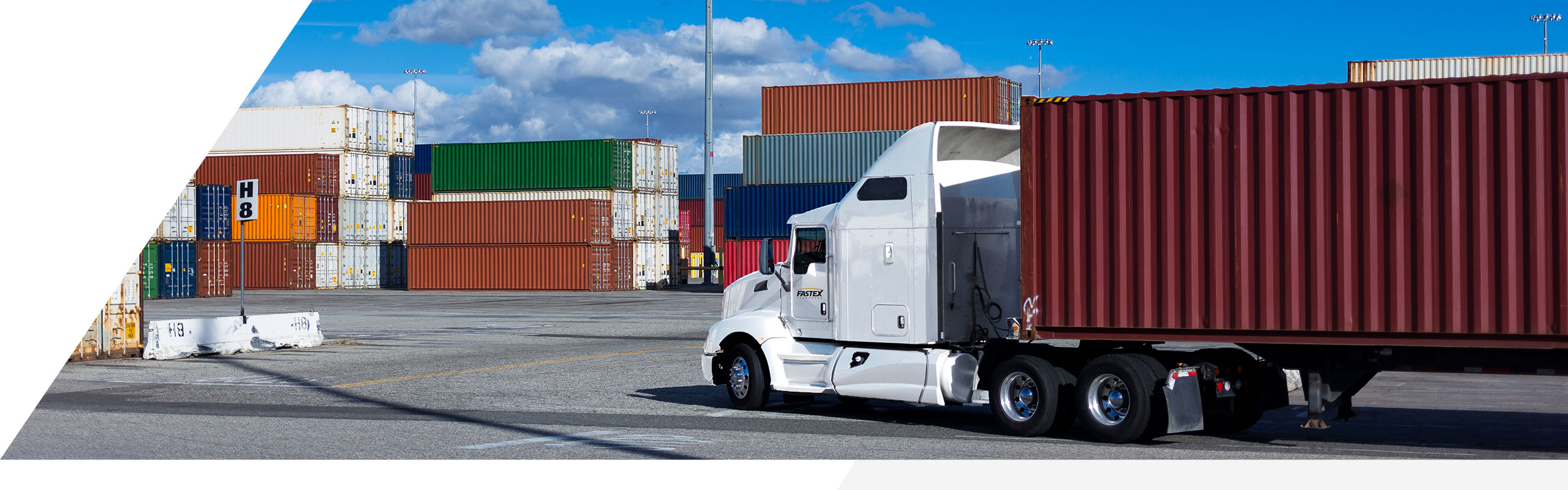 A Fastex transport pulling into a container yard. 